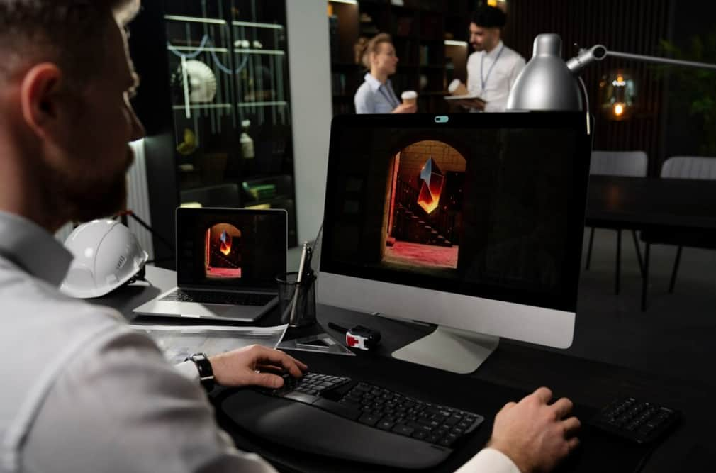 An editor adjusts a 3D model on a computer in a modern office