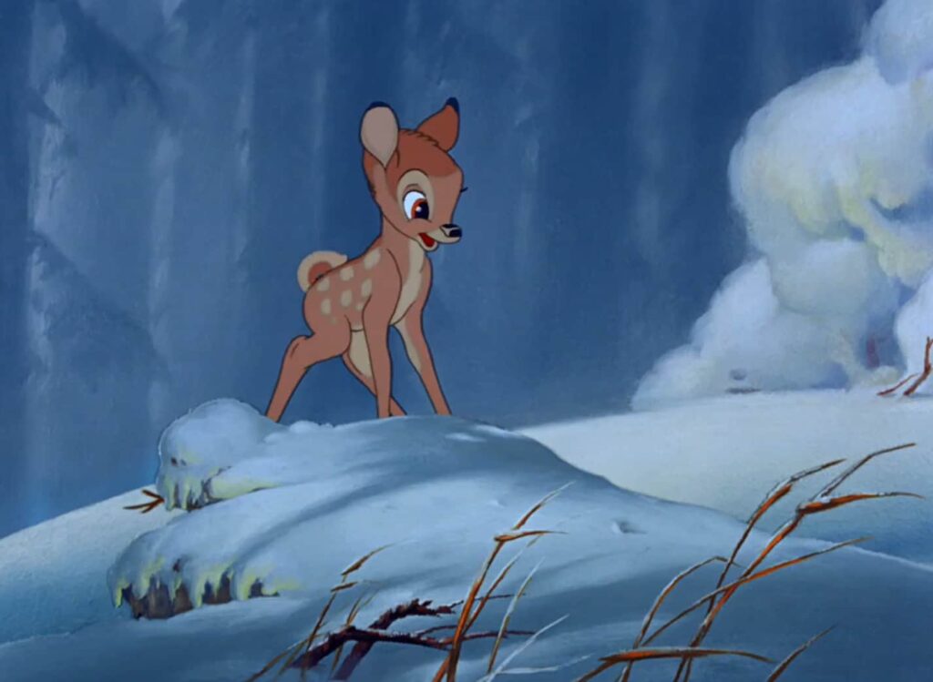 Bambi standing on a snow-covered hill with a curious expression